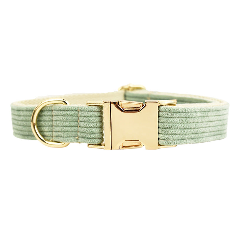 A set of dog pet accessories including a collar, leash, bow, flower decoration, and a vest, all in green with a gold leaf pattern.
