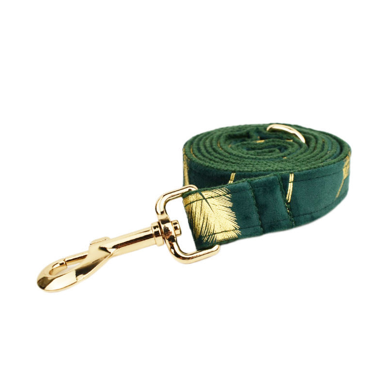 A set of dog pet accessories including a collar, leash, bow, flower decoration, and a vest, all in green with a gold leaf pattern.