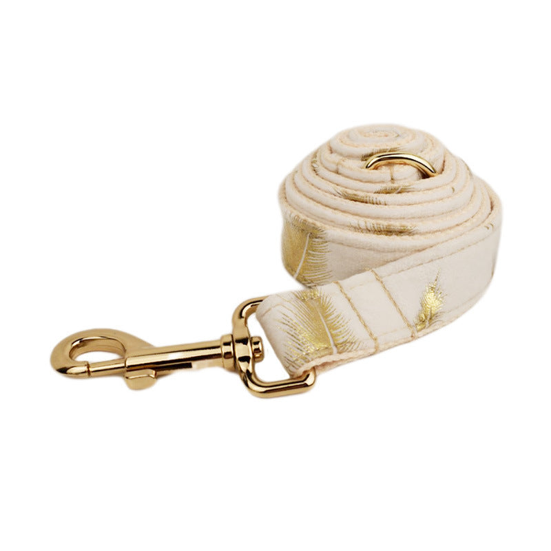 A set of dog pet accessories including a collar, leash, bow, flower decoration, and a vest, all in green with a gold leaf pattern.