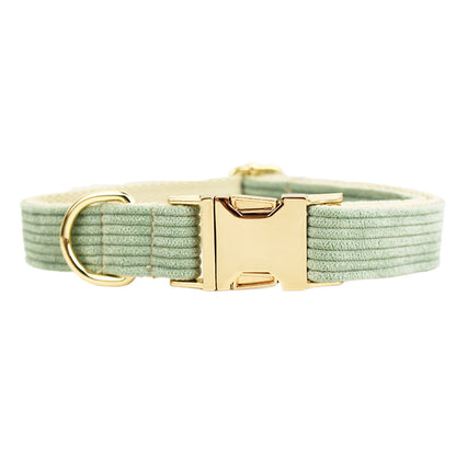 A set of dog pet accessories including a collar, leash, bow, flower decoration, and a vest, all in green with a gold leaf pattern.